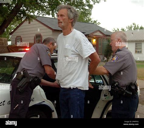 Enid Police Officers Take A Man Into Custody During A Large Scale Drug