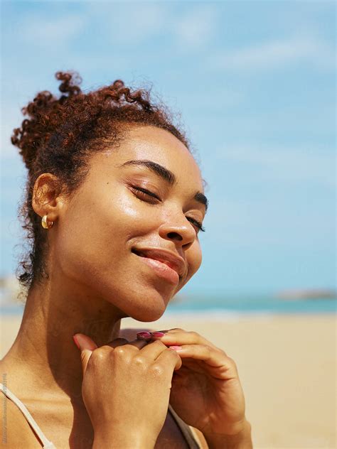 Happy Radiant Woman With Just Applied Sunscreen At Beach Vacation By