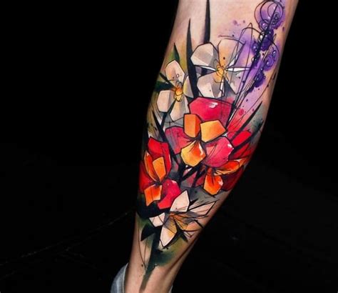 A Colorful Flower Tattoo On The Leg