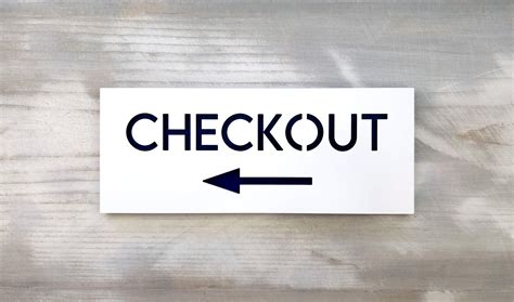 Checkout sign with arrow. Check out this way sign. Directional signs