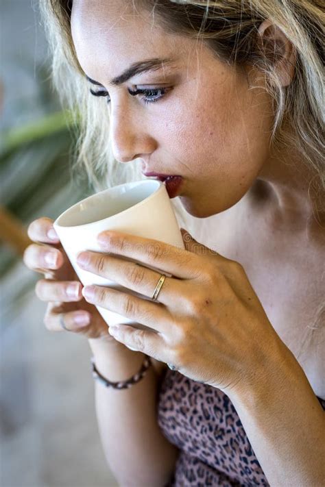 Sunlit Sips Serene Mornings a Blonde Beautyâs Peaceful Start in Paradise Stock Image