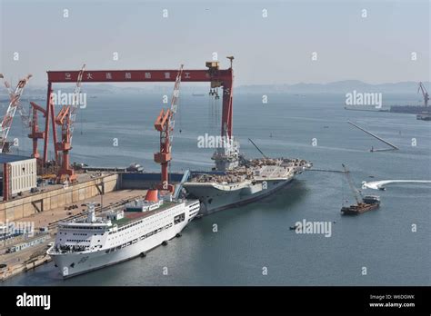 Chinese Workers Labor On The Deck Of Chinas First Domestically Built