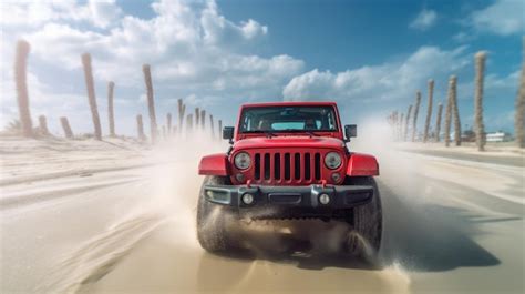 Premium Ai Image A Red Jeep Wrangler Driving Through The Sand