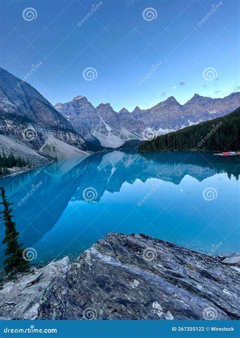 Vertical Shot Of A Clear Blue Lake Surrounded By A Forest And A