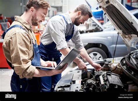 Mechanics Working in Car Service Stock Photo - Alamy 