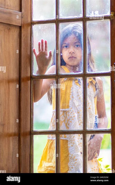 Brunette Girl Behind Wooden And Glass Door Stock Photo Alamy