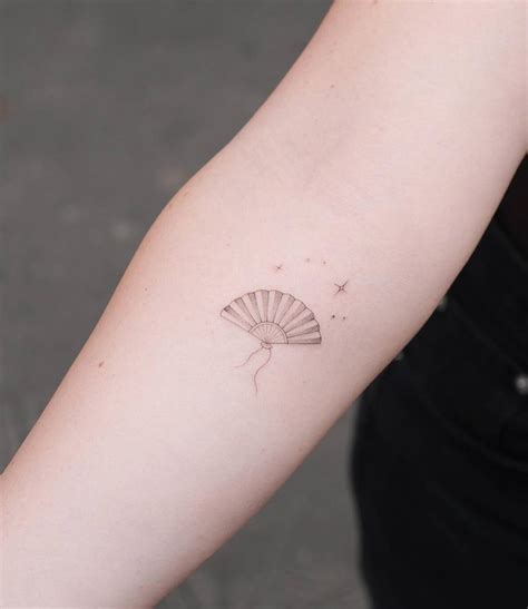 Single needle hand fan tattoo located on the inner