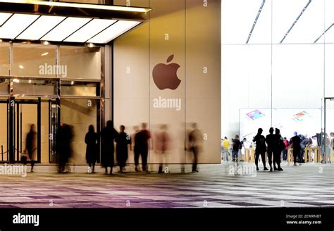 FILE Pedestrians Walk Past An Apple Store In Qingdao City East