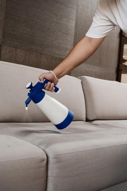 Premium Photo Spraying Detergent On Couch For Dry Cleaning Using