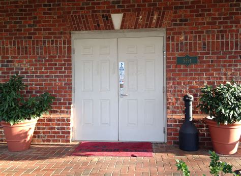 White Double Doors With Straight Keystone Design And Rustic Village