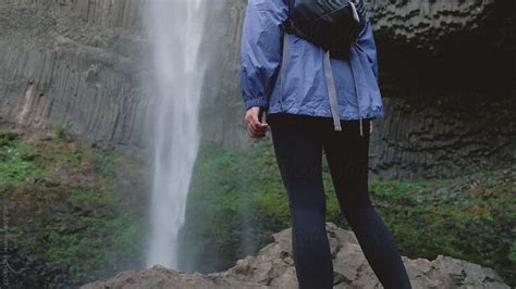 Woman Looking At Large Waterfall By Stocksy Contributor Rzcreative