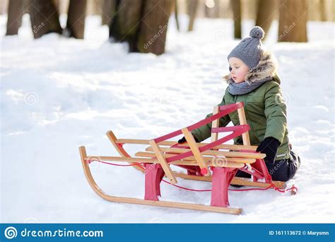 Cute Little Boy With Broken Sled On A Walk In Snowy Park Frustrated