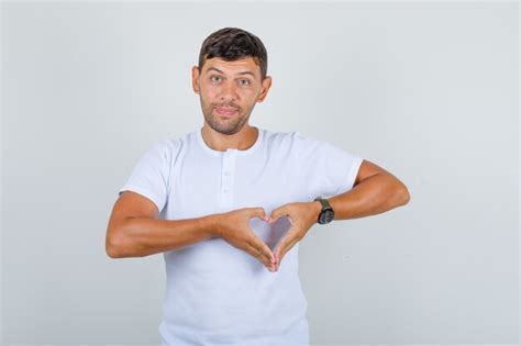 Free Photo Young Man In White T Shirt Making Heart Gesture With