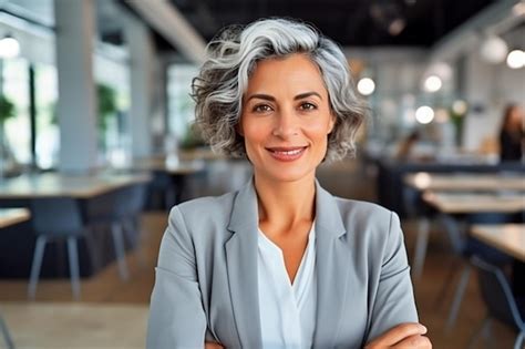 Premium Photo Elegant Middleaged Latina Manager In The Workplace Contented Middleaged Woman