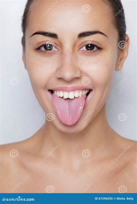 Beautiful Woman Sticking Out Her Tongue And Showing Young Piercing