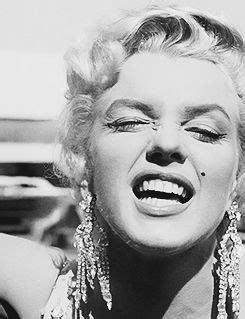 marilyn monroe laughing with her eyes closed