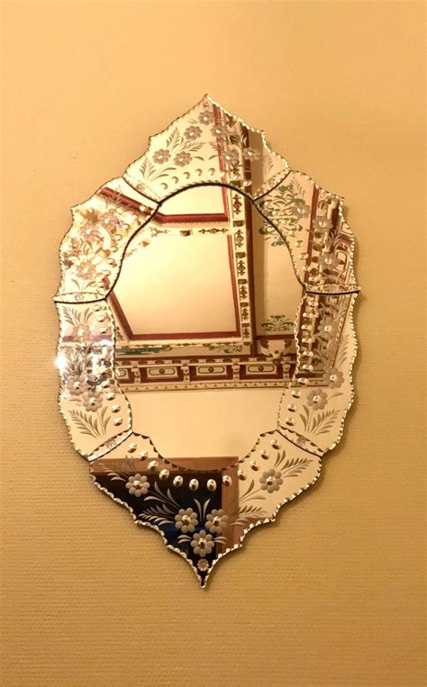 A Decorative Mirror Hanging On The Wall