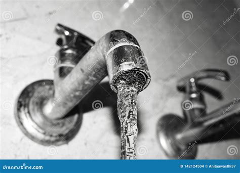 Crystal Clear Fresh Water Stream From Metal Tap Black And White Stock