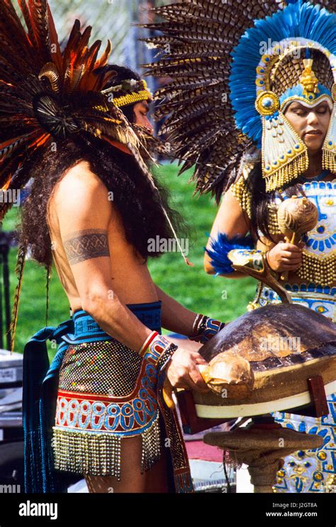 Aztec Man Dressed In Traditional Regalia Plays A Large Turtle Shell