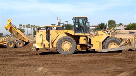 Cat H Wheel Dozer Pushing Dirt And Compacting Volvo A G Adts