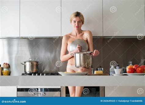 Naked Woman In The Kitchen In The Morning And Cooking Healthy Food Sensual Housewife Stock