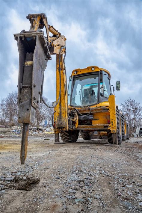 Excavator With Hydraulic Breaker Hammer For The Destruction Of Concrete