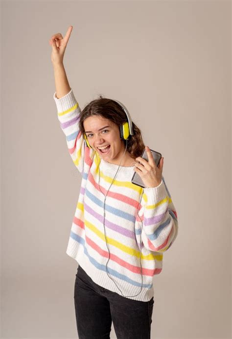 Menina Nova Bonita Do Adolescente Nos Fones De Ouvido Que Escuta A M