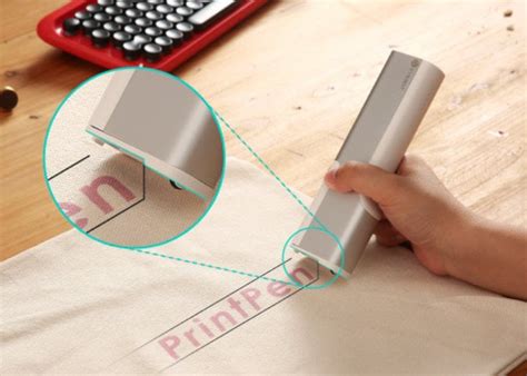 PrintPen handheld printer, prints on a variety of surfaces and ...