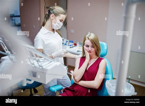 Triste paciente con dolor de muelas sentado en un sillón dental