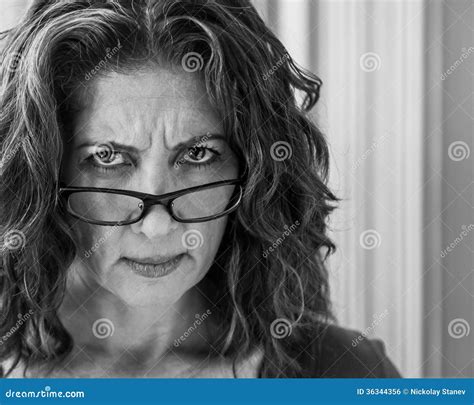 Angry Middle Aged Woman Frowning Listening To Noise Or Music Stock