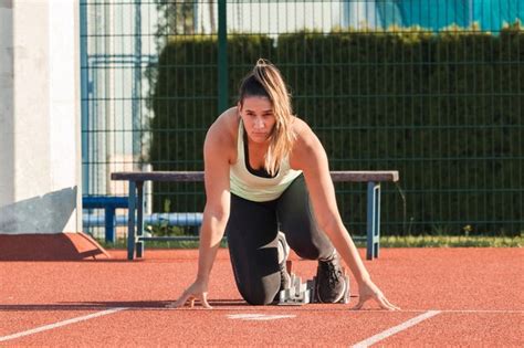 Premium Photo Woman Taking Sprint Start Position During An Intensive