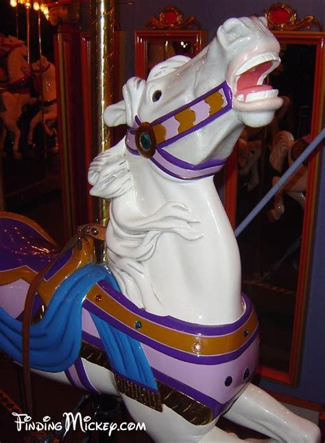 a merry go round horse with its mouth open