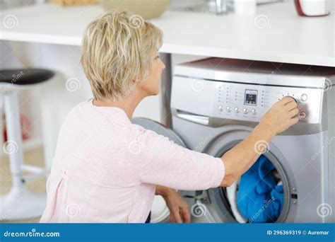 Mature Woman Using Washing Machine Stock Image Image Of Laundry