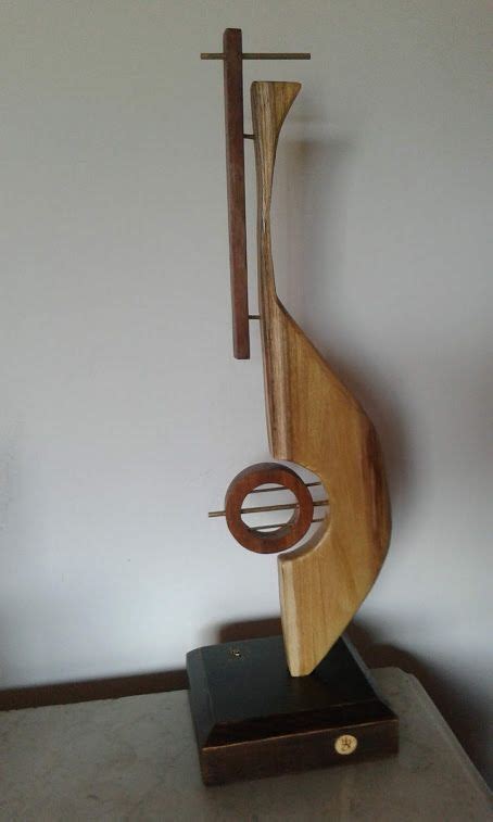 A Wooden Sculpture Sitting On Top Of A Table