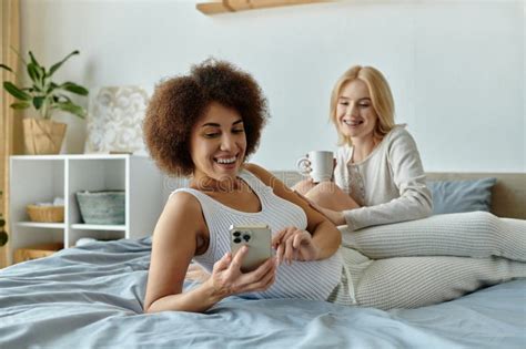 A Lesbian Couple Relaxes At Home Stock Photo Image Of Happiness Homewear