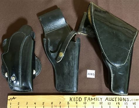 LOT OF 3 - LEATHER HOLSTERS - INCL BUCHEIMER SEMI-SHOULDER HOLSTER AND POLICE REVOLVER HOLSTERS