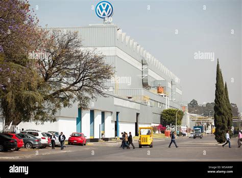 People Walk Past The Volkswagen Factory In Puebla Mexico On Wednesday