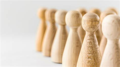 Row Of Wooden Pegs Against White Background Premium Ai Generated Image