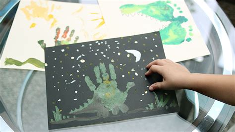 Dinosaur Kids Craft with Handprints and Footprints - MidKid Mama