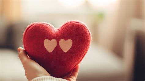 Premium AI Image A Person Holding A Red Heart With Two Hearts Cut Out