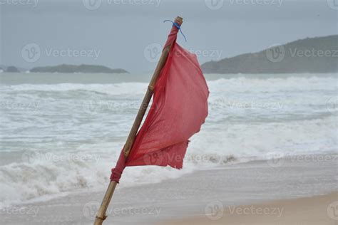 Red flag on beach 10517059 Stock Photo at Vecteezy