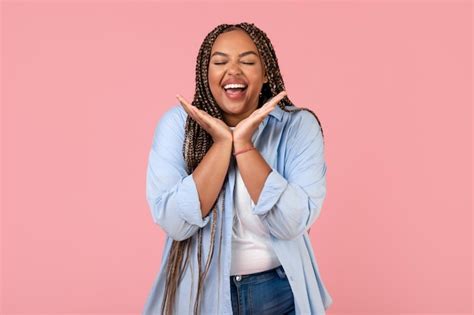 Premium Photo | Cheerful plump woman laughing posing with eyes closed ...