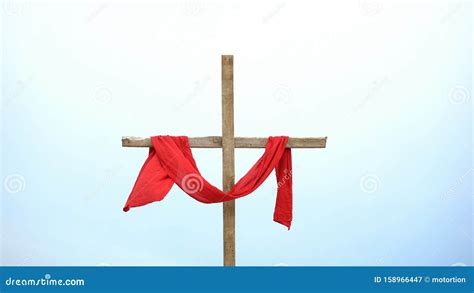 Wooden Cross With Red Cloth Wrapped Around Crucifix And Resurrection