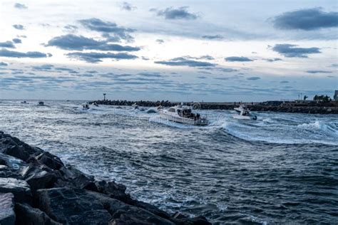 Boats Racing Out of the Manasquan Inlet at Sunrise Stock Image - Image ...