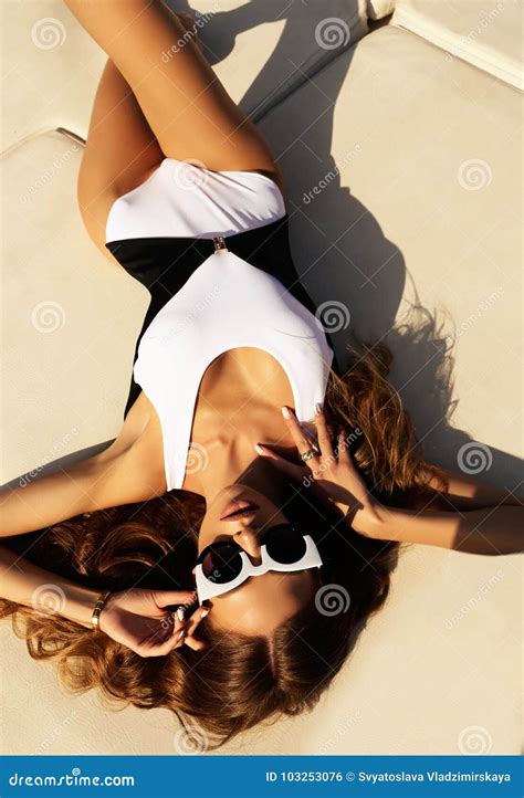 Girl With Dark Hair In Luxurious Bikini Relaxing On Yacht I Stock Photo