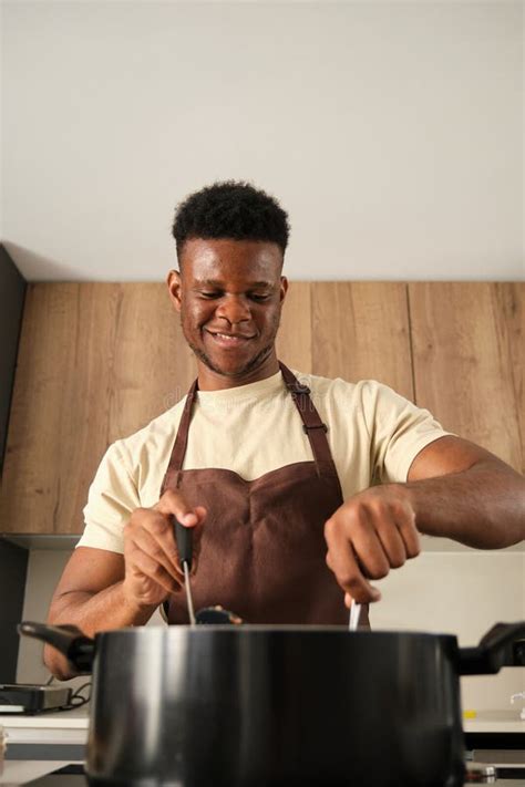 Young Black Cooking in a Big Pot. Stock Photo - Image of apron ...