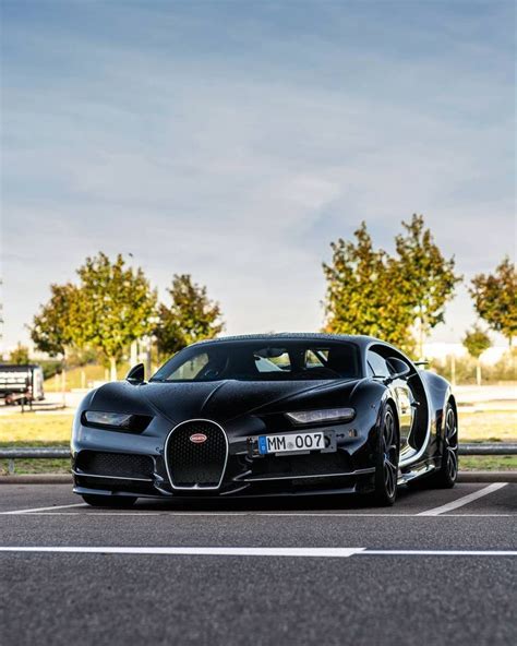 A Black Bugatti Is Parked In A Parking Lot