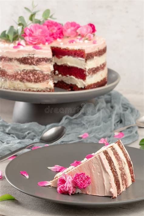 Red Velvet Naked Cake With Fresh Roses And Swiss Buttercream On Kitchen Countertop Stock Photo