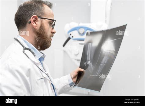 Doctor Examine A Film X Ray Of A Patient At Radiology Room High