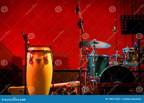 Traditional Ethnic Cuban Conga Drum And Modern Drum Set On Red